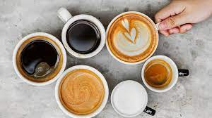 A person is holding a cup of coffee in their hand.