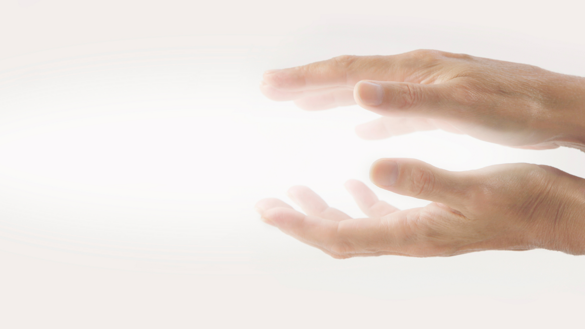 A person 's hands are reaching out towards a white background.