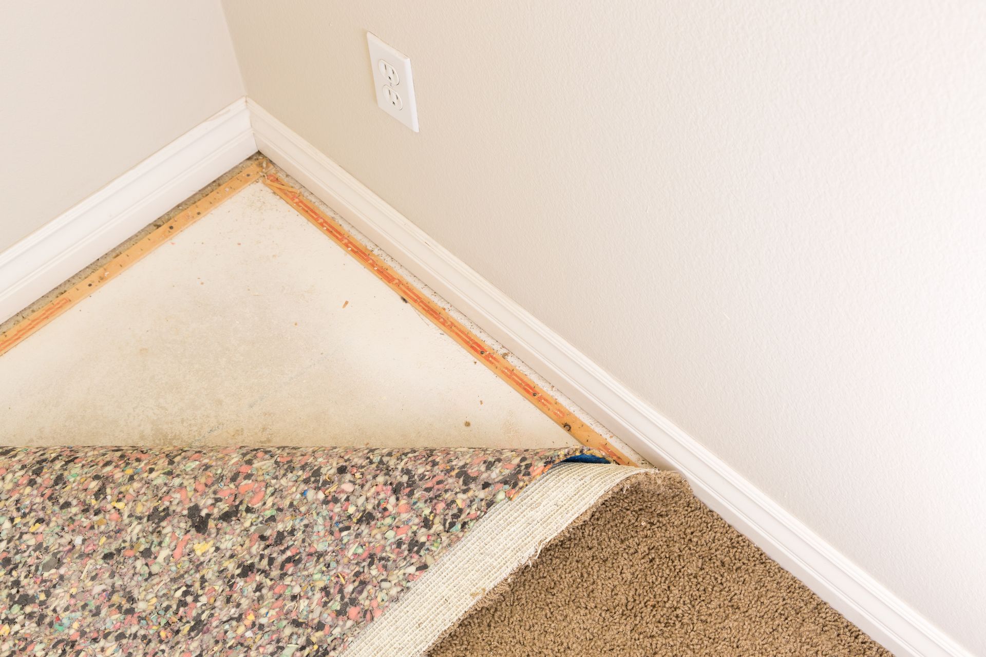 Pulled back carpet and padding in room, All Brite Floors Houston