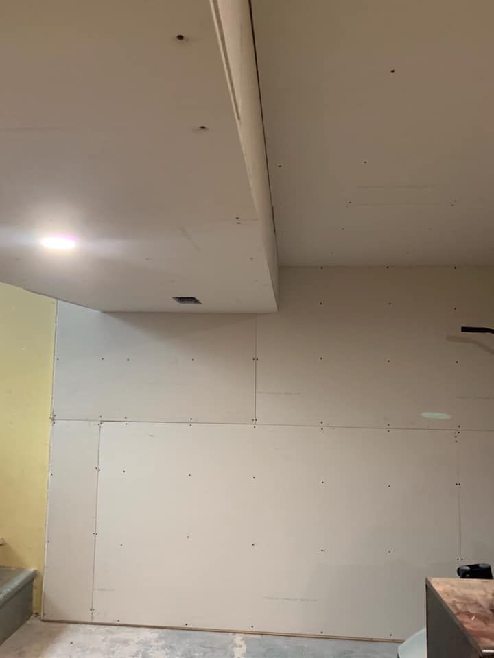 A room with a ceiling and a wall that is being remodeled.