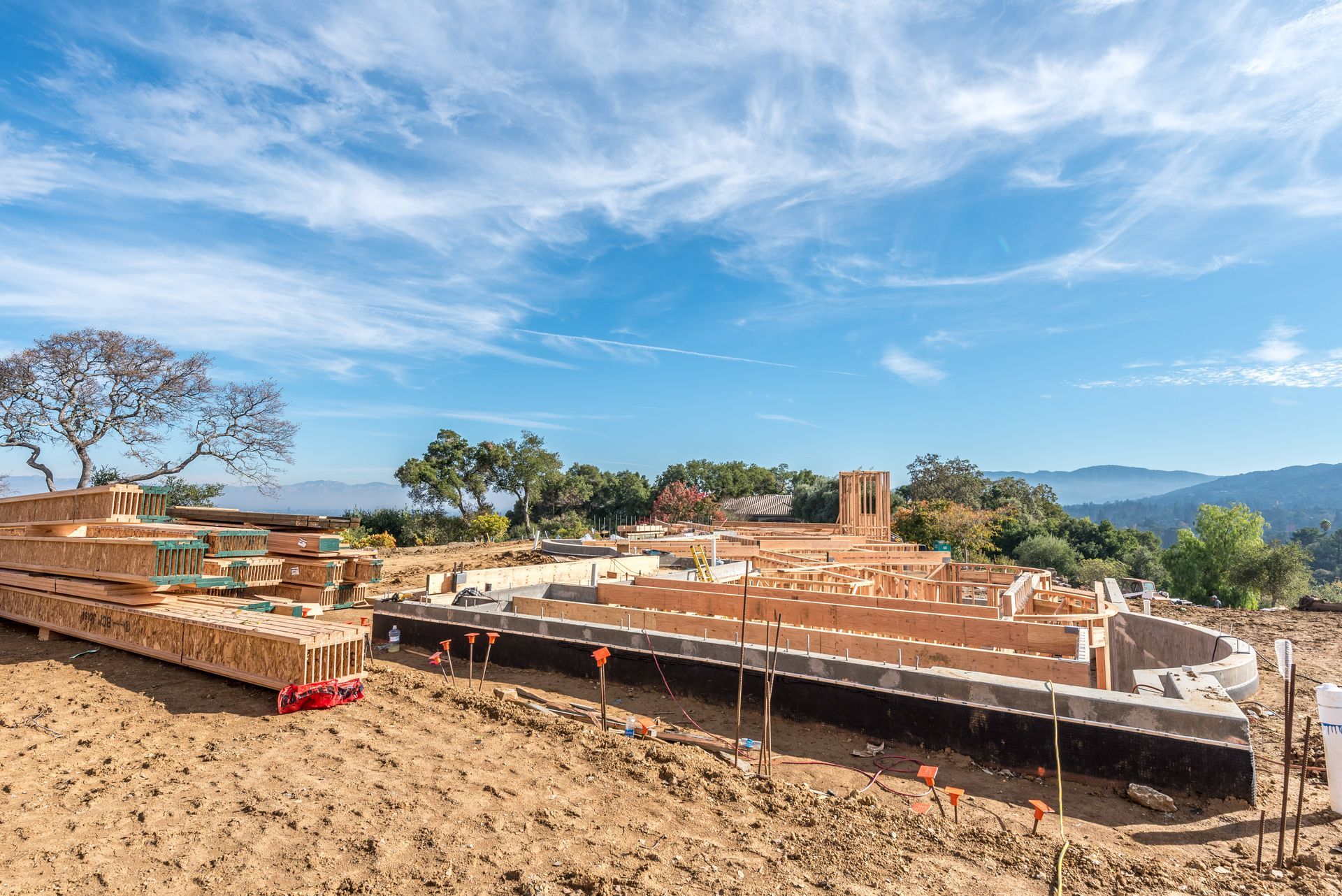 Foundation under construction on a hillside under a blue sky