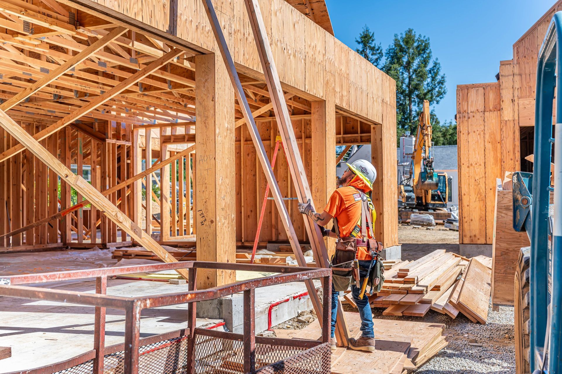 S. R. Freeman crew coordinating structural steel and wood framing on a custom home