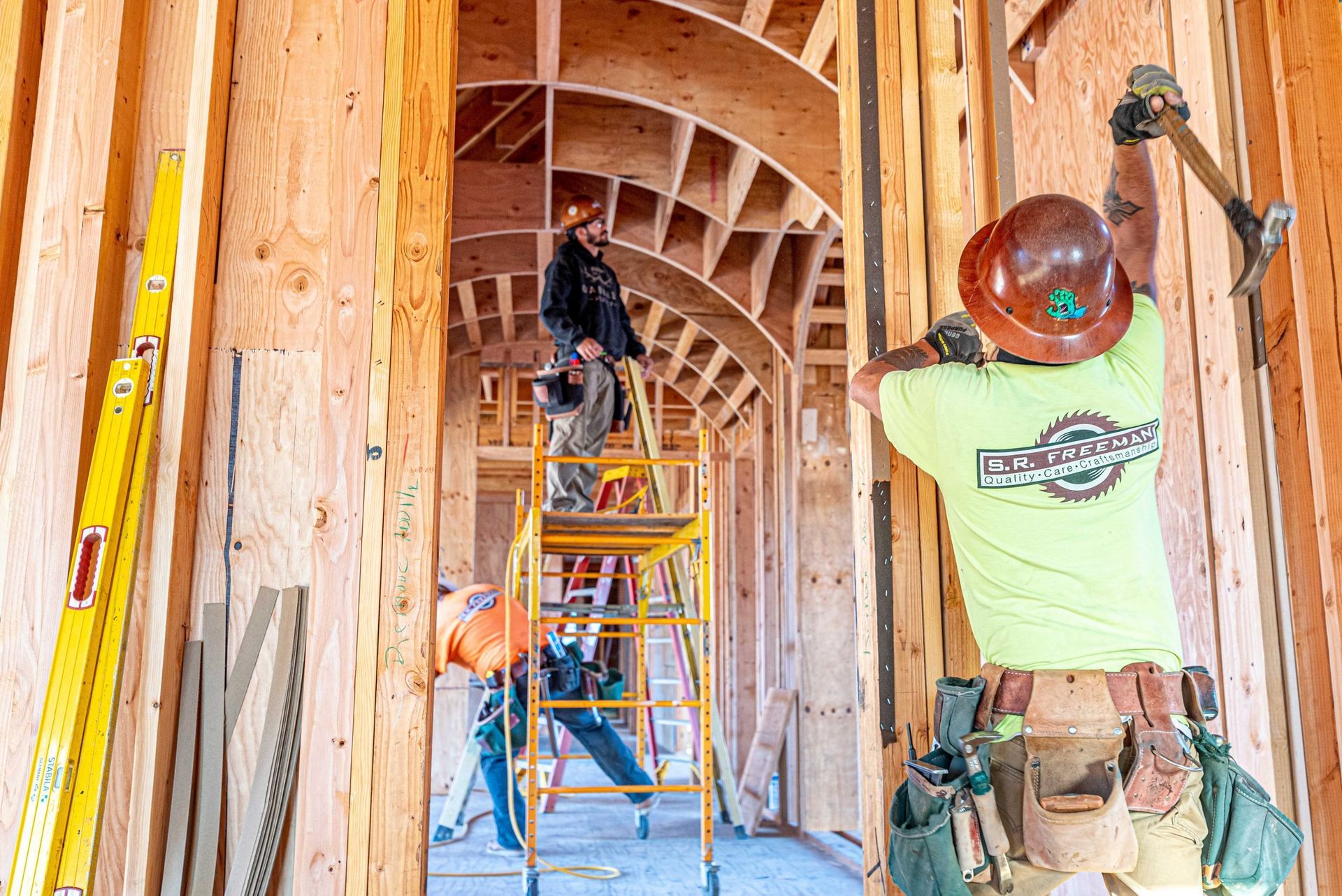 S. R. Freeman crew coordinating structural steel and wood framing on a custom home