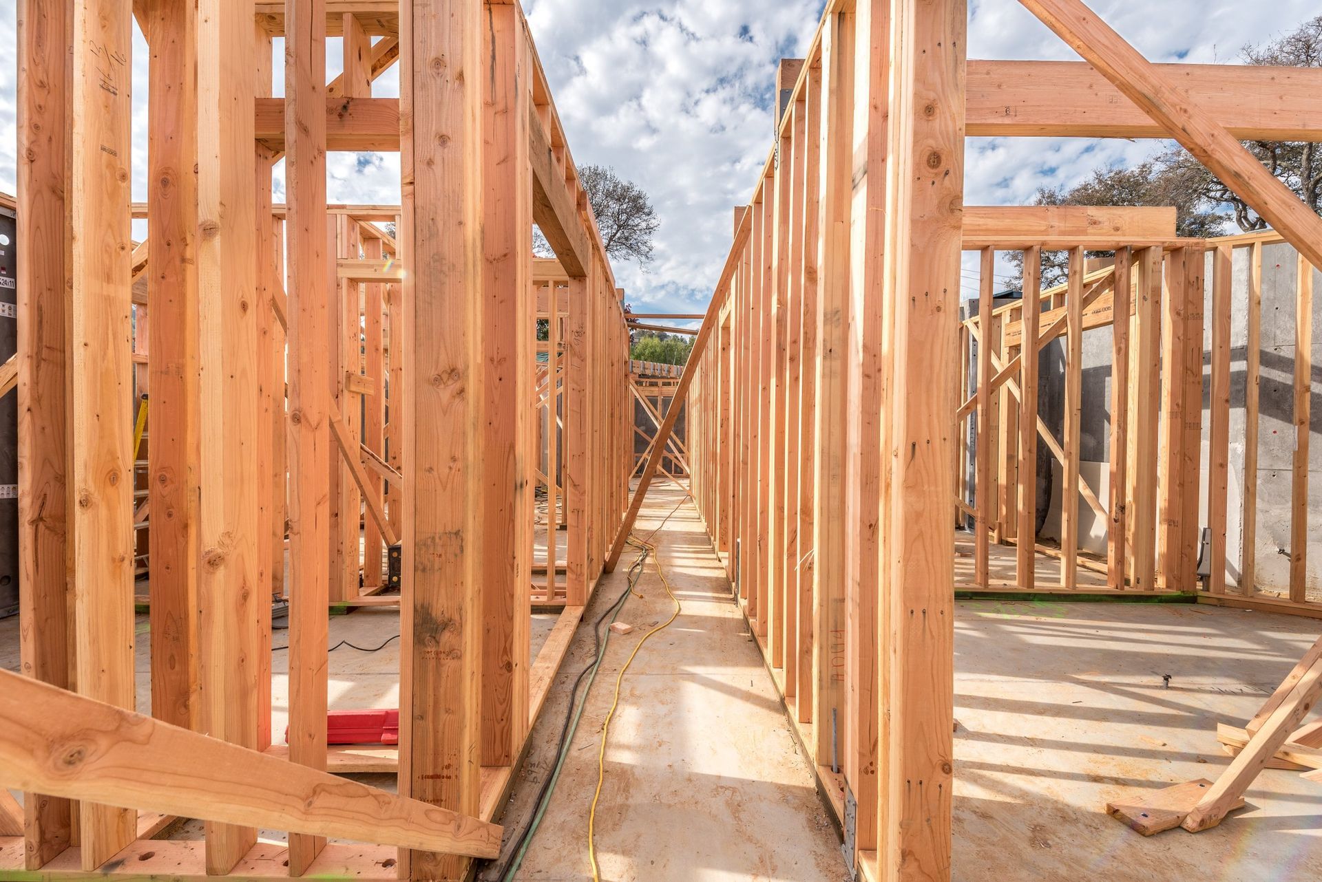S. R. Freeman crew coordinating structural steel and wood framing on a custom home