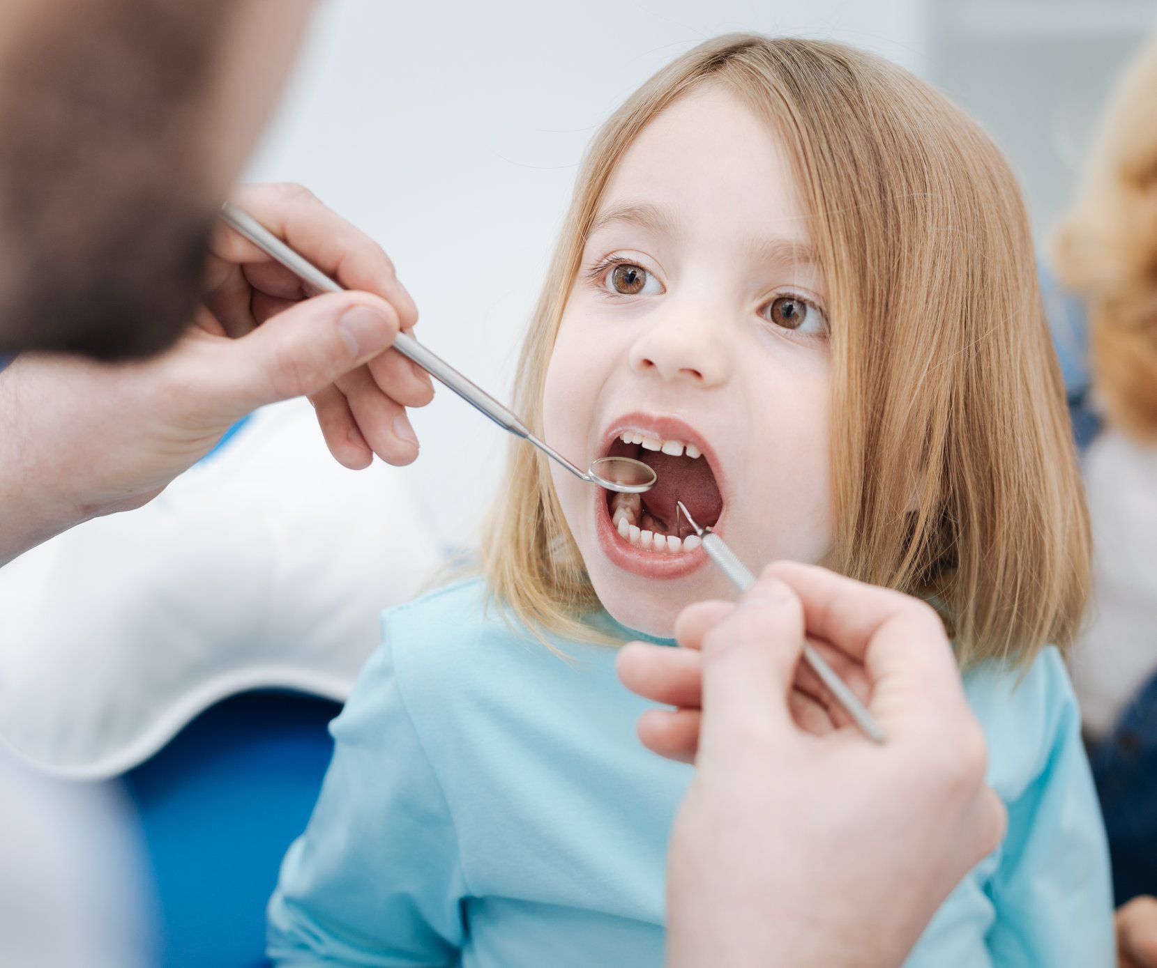 Child With Open Mouth at Dentist, Dental Tools in View — Trinity Beach Dental In Trinity Beach, QLD
