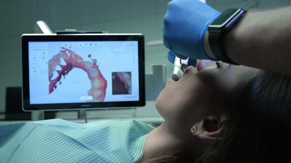 Dentist Examining a Patient's Mouth With a Digital Display — Trinity Beach Dental In Trinity Beach, QLD