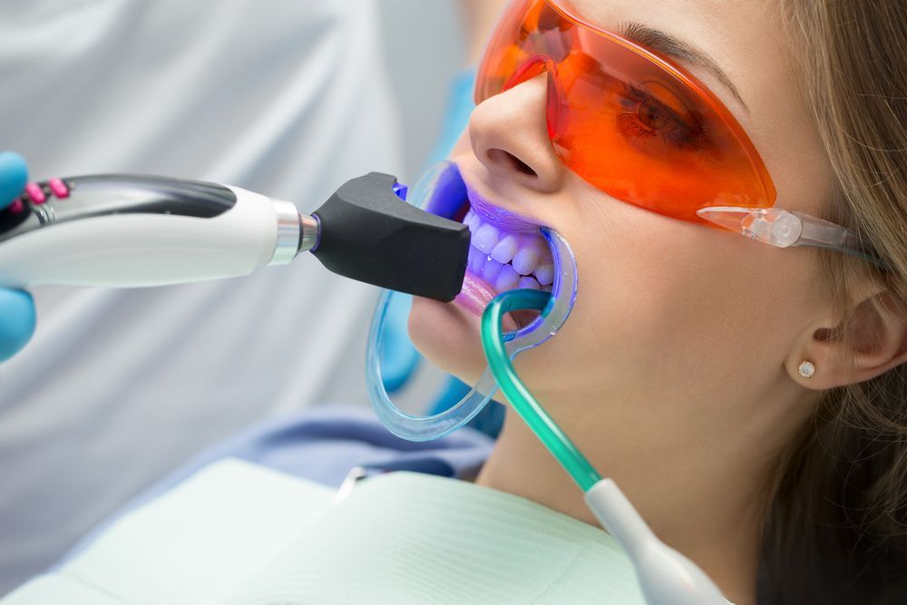 Woman Receiving Teeth Whitening Treatment at a Dental Clinic — Trinity Beach Dental In Trinity Beach, QLD