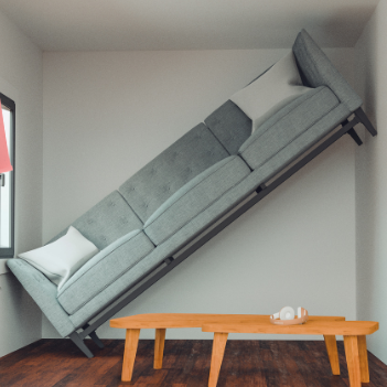 A sofa that is sitting diagonally in a living room, up the wall.