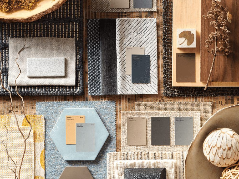 Mood board with fabric swatches, paint chips in neutral tones, wood textures, and decorative elements.