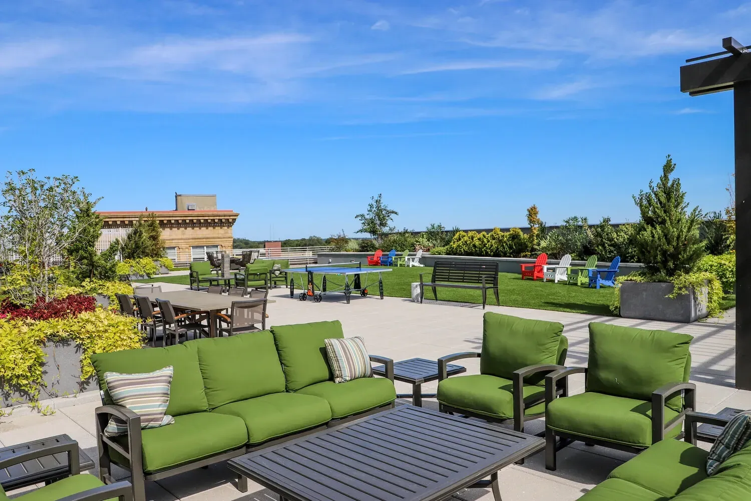 Rooftop lounge area with seating, tables, and a ping pong table.