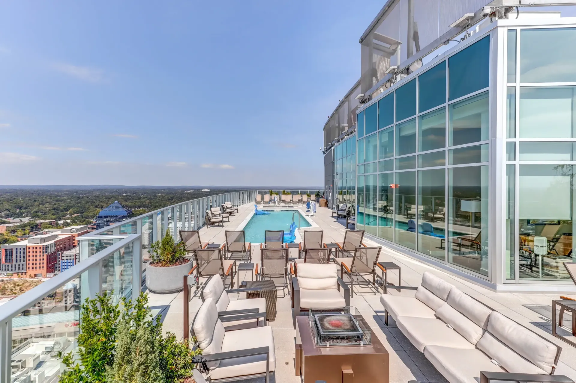 Rooftop pool and lounge area with city views.