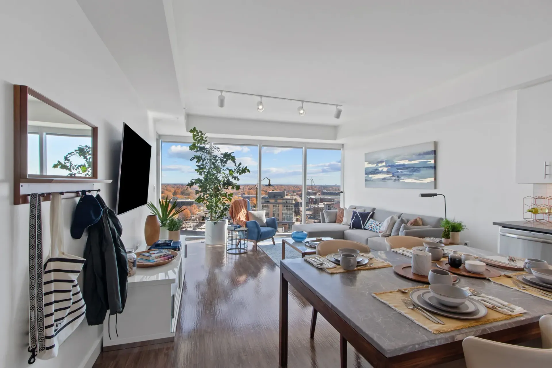 Modern apartment living and dining area with city views.