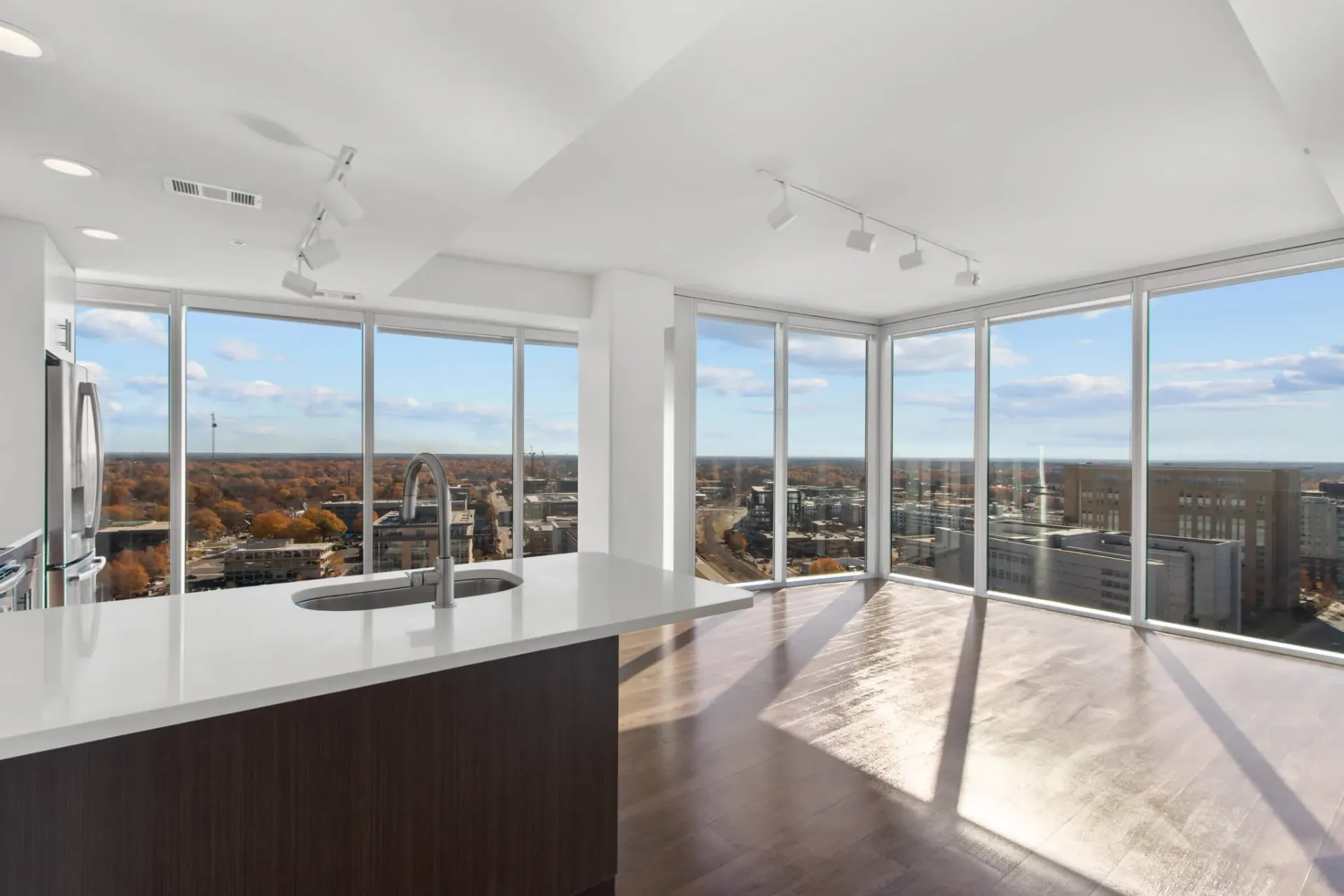 Modern kitchen island with sink and large windows with city view