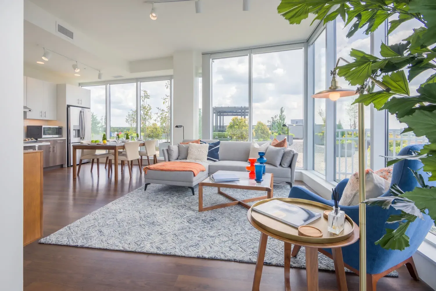 Open-concept living and dining area with modern furniture and large windows