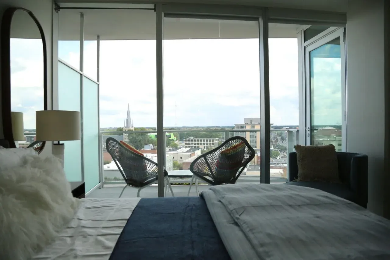 Bedroom with balcony and city view