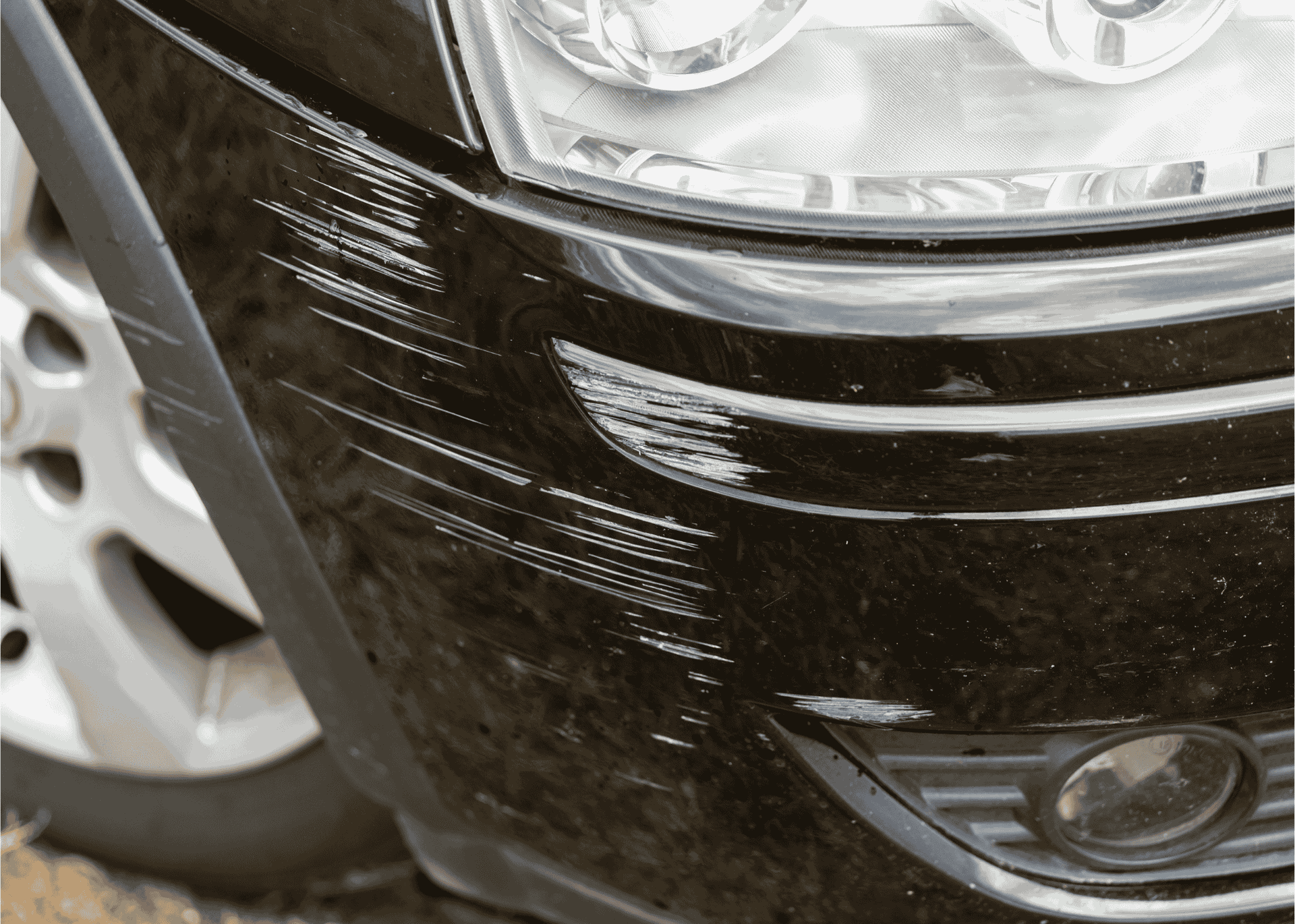 Black car with scratches across the front bumper
