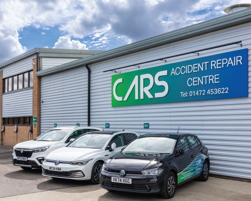 Shiny cars parked outside CARS of Grimsby accident repair centre.
