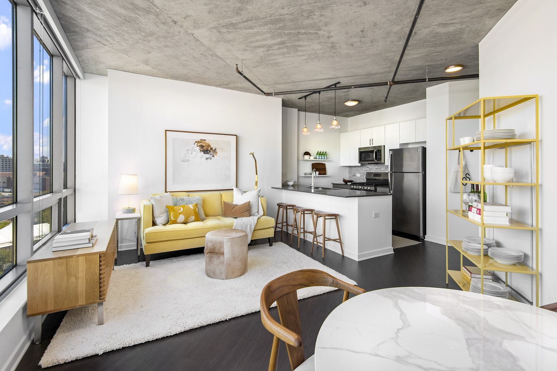 a living area with a kitchen and a dining room