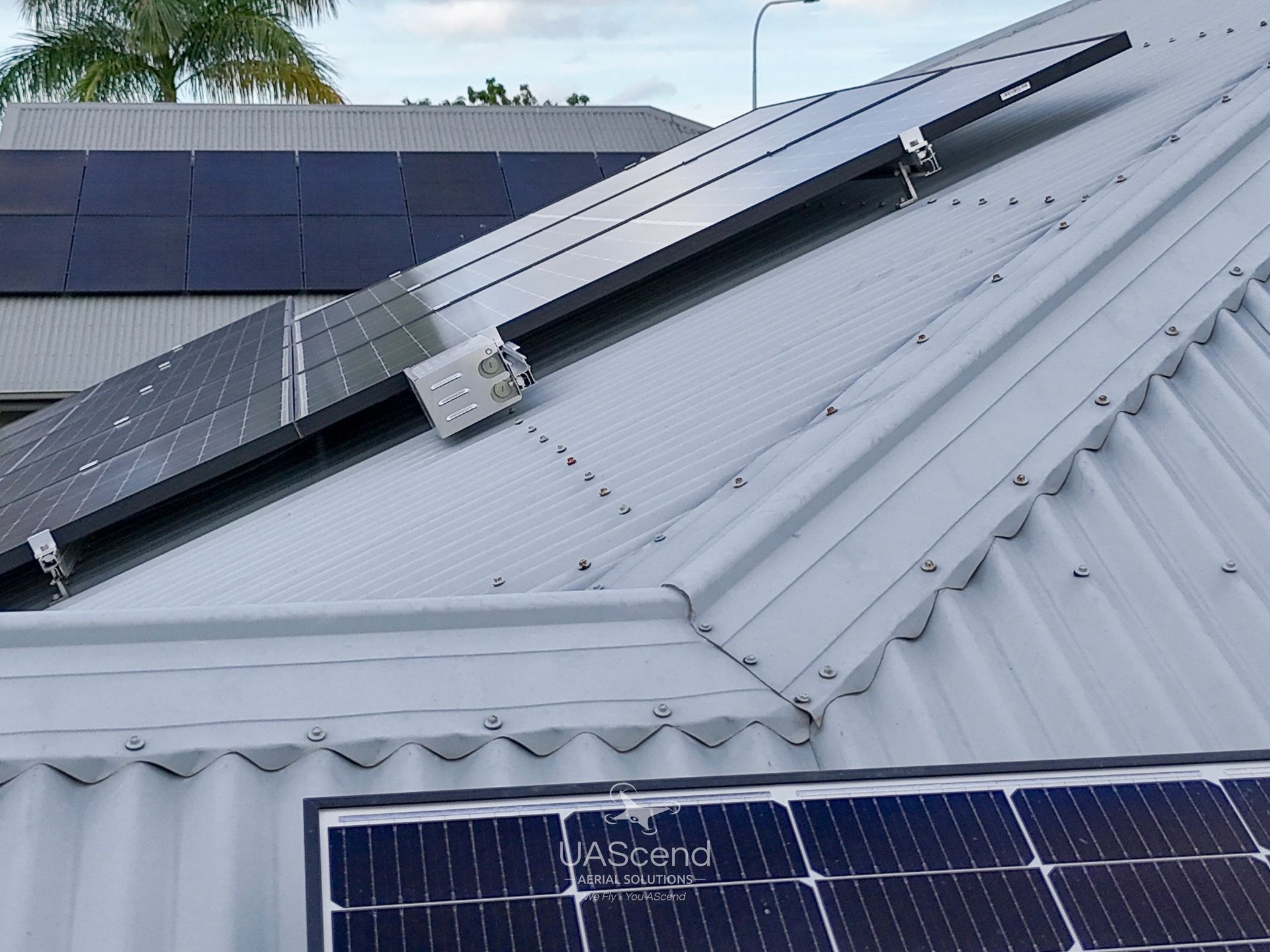 Solar Panels Mounted on a Gray Corrugated Metal Roof — UAScend Aerial Solutions in Townsville, QLD