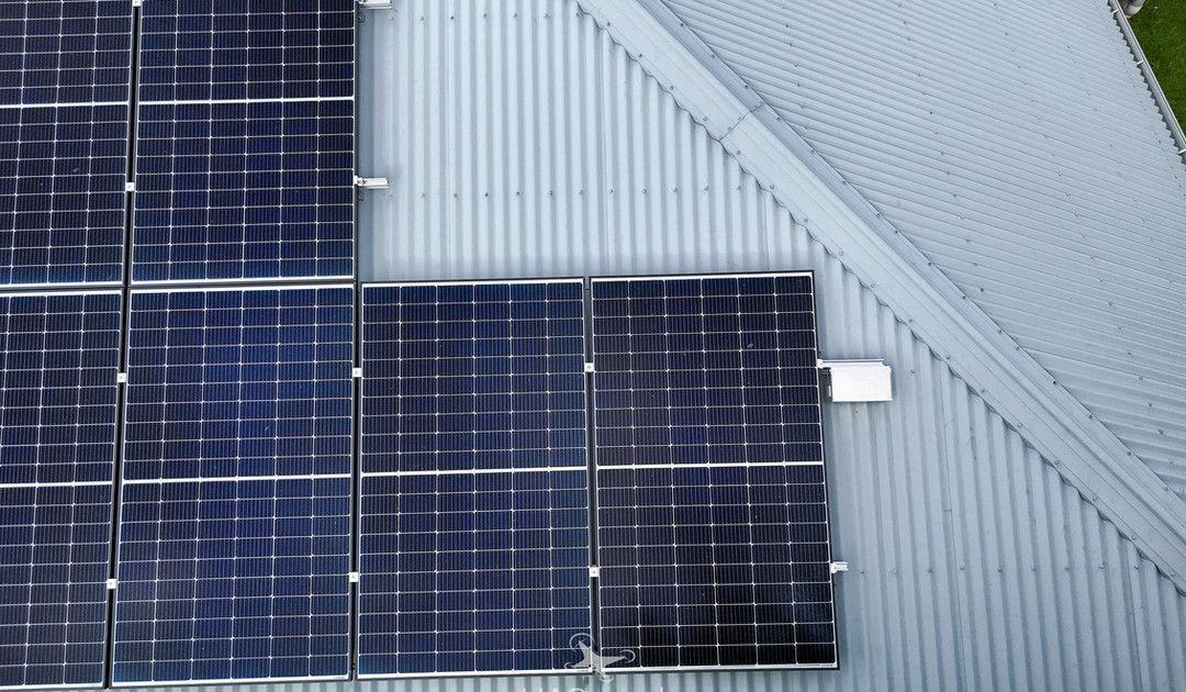 Solar Panels Mounted on a Light Gray Corrugated Metal Roof — UAScend Aerial Solutions in Townsville, QLD