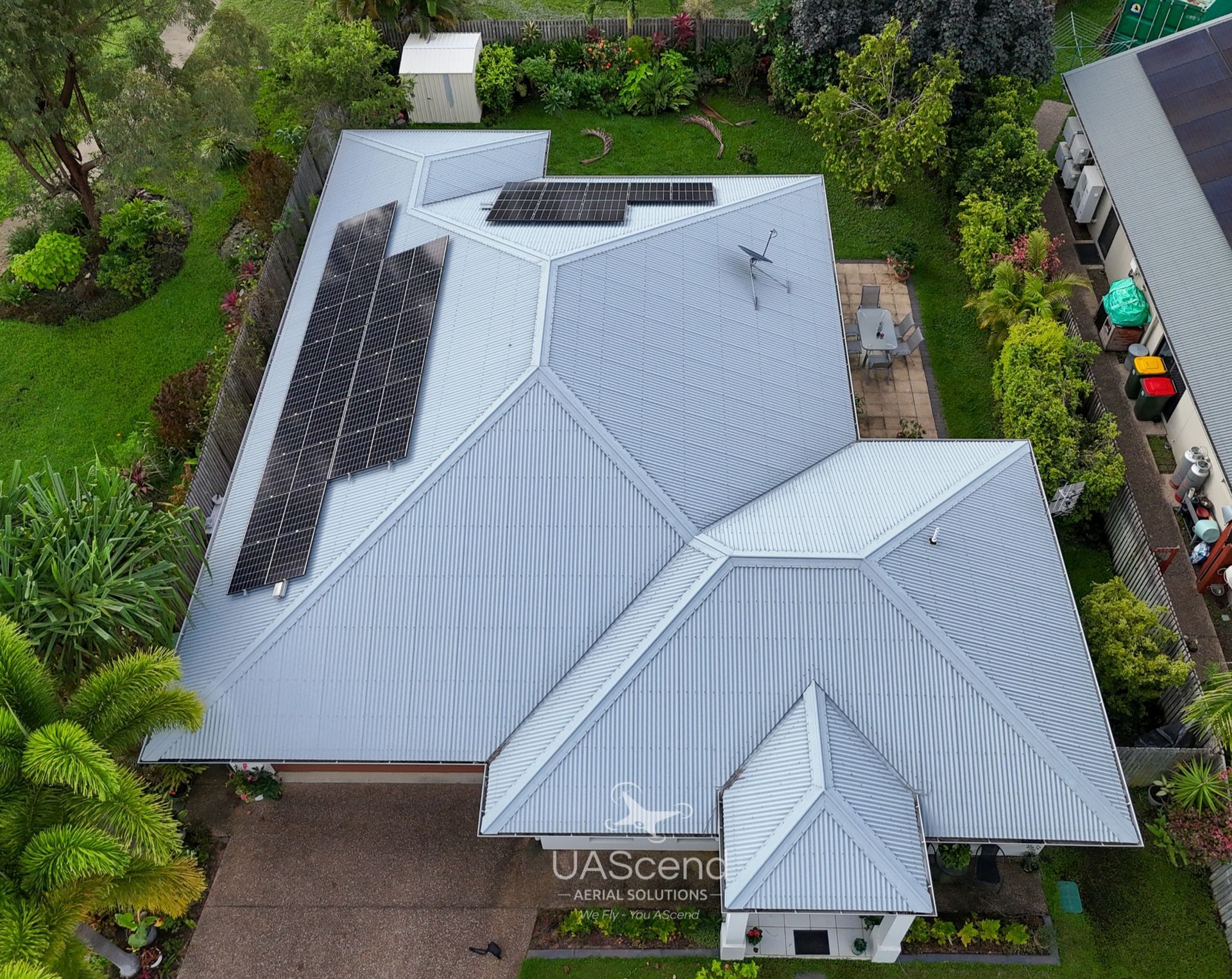 Two White Roof Vents Standing On A Metal Roof Between Two Solar Panel Arrays — UAScend Aerial Solutions in Townsville, QLD