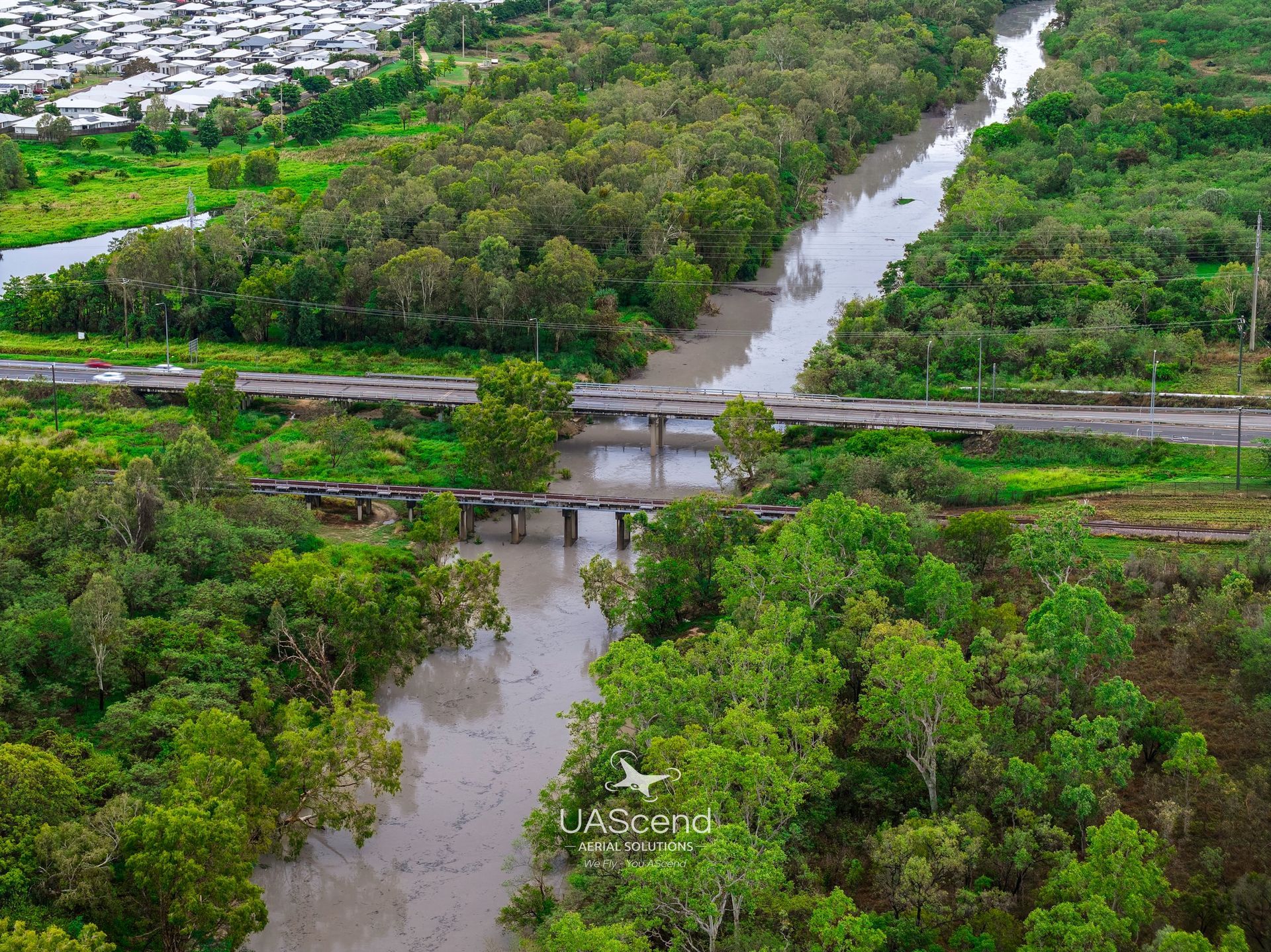 Aerial View of a Flooded River With a Bridge — UAScend Aerial Solutions in Townsville, QLD