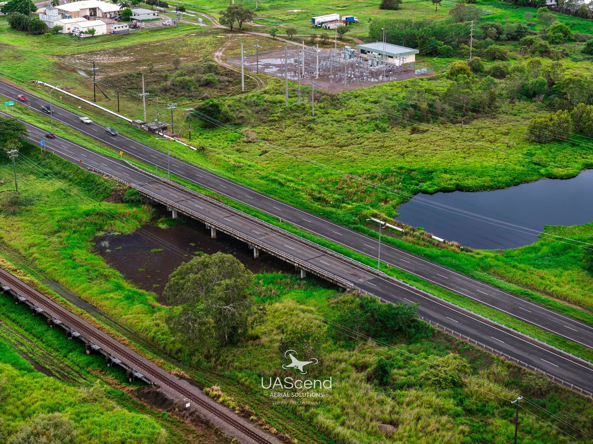 Aerial View of a Road Crossing Green Wetlands — UAScend Aerial Solutions in Townsville, QLD