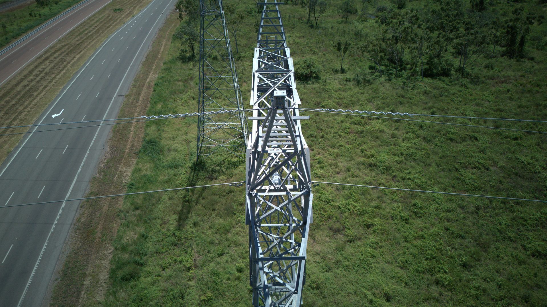 A Metal Transmission Tower Beside a Highway — UAScend Aerial Solutions in Townsville, QLD