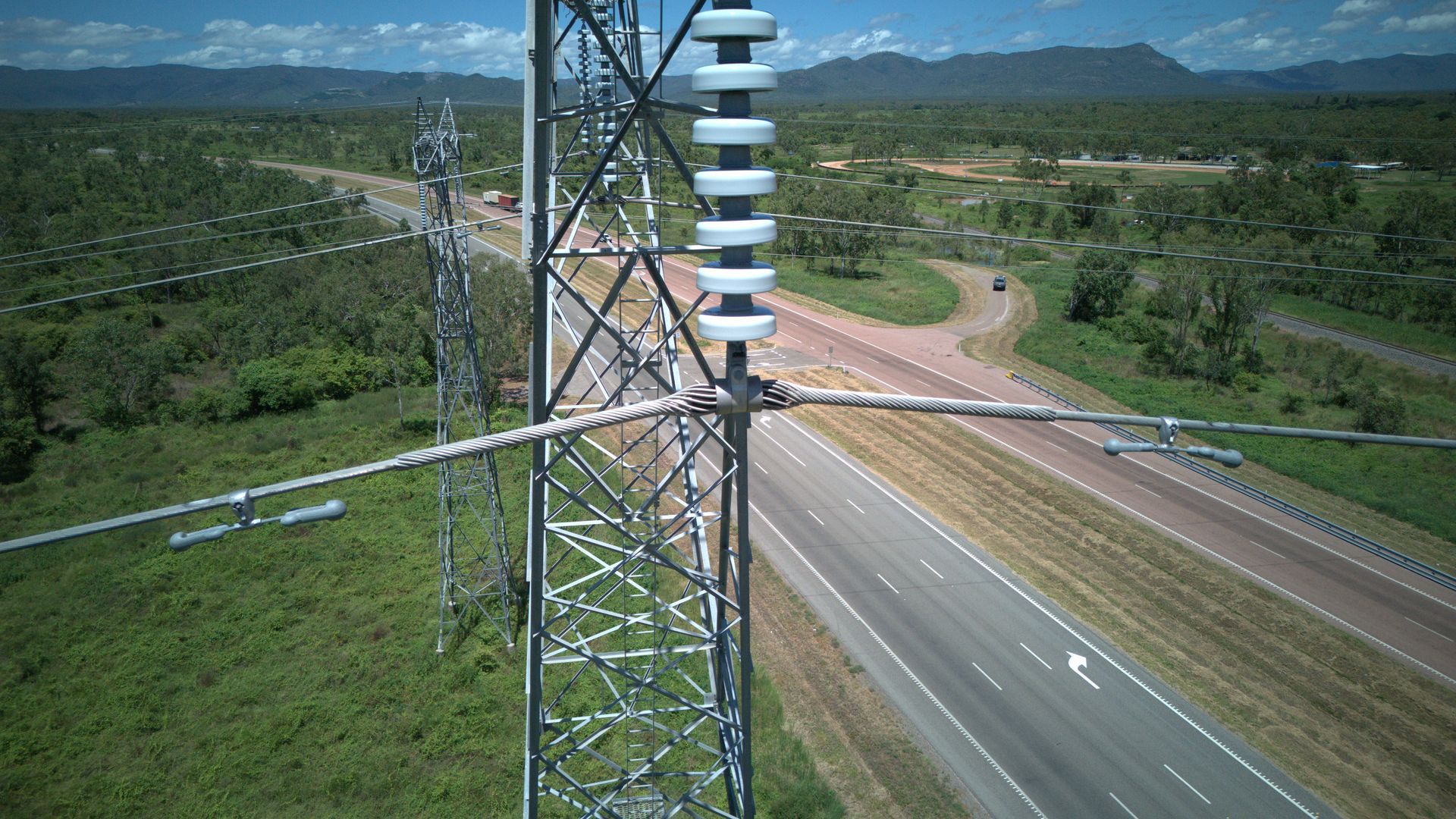 Highway Beside a Metal Tower and Blue-striped Silo — UAScend Aerial Solutions in Townsville, QLD