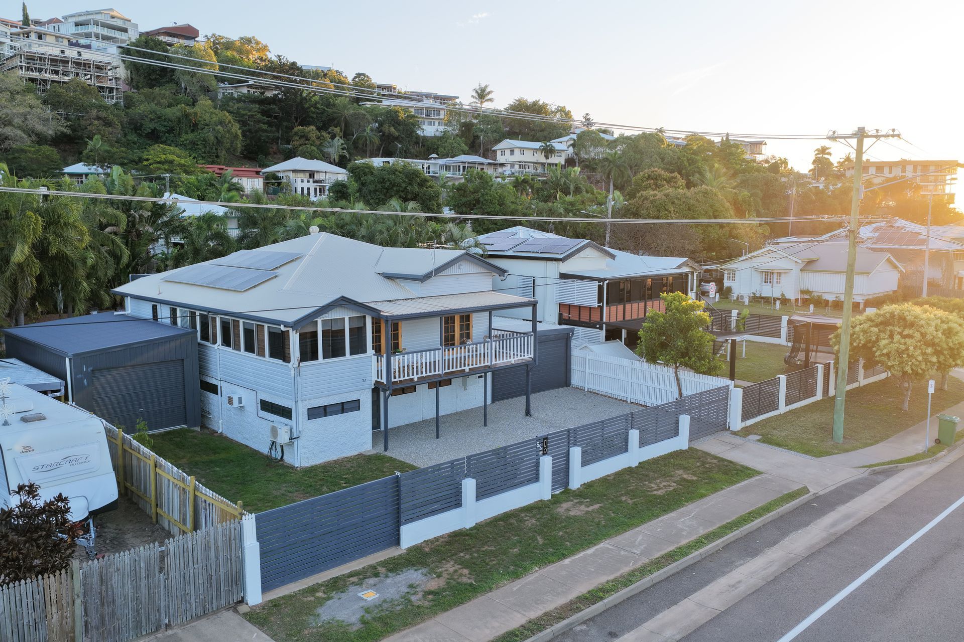 A Modern White House With a Gray Fence Beside a Road — UAScend Aerial Solutions in Townsville, QLD