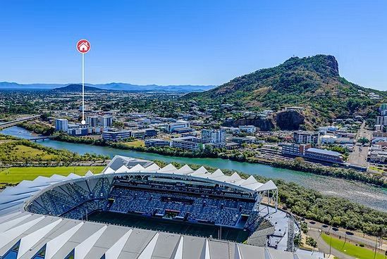 An Aerial View of Dark Blue Solar Panels Mounted on A Metal Roof — UAScend Aerial Solutions in Townsville, QLD