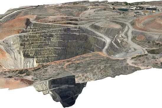 Open-pit mine with terraced rock walls and winding haul roads — UAScend Aerial Solutions in Townsville, QLD