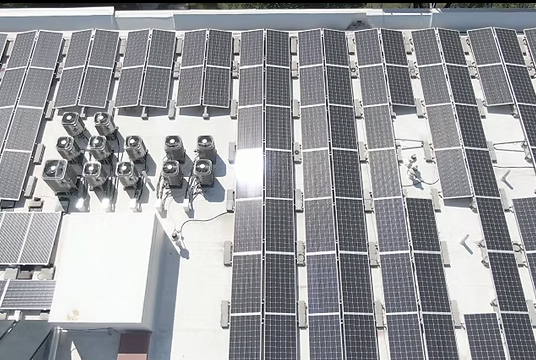 Solar panels and rooftop equipment on a white industrial roof, viewed from above. — UAScend Aerial Solutions in Townsville, QLD