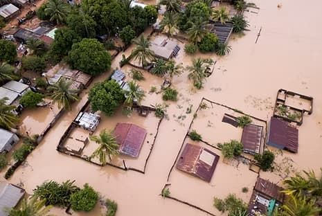 An Aerial View of A Neighborhood Submerged in Muddy Brown Floodwaters — UAScend Aerial Solutions in Townsville, QLD