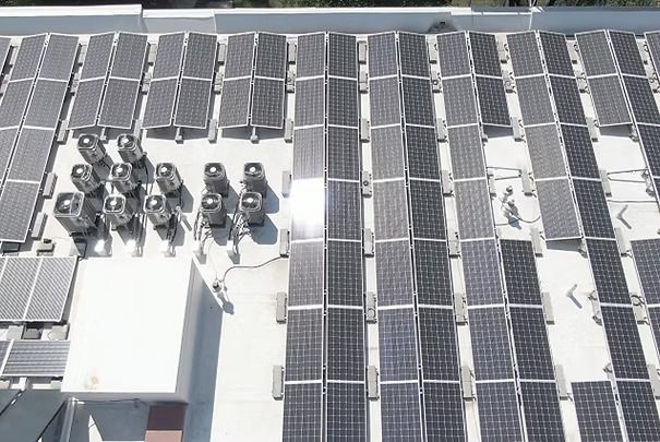 Rooftop With Rows of Solar Panels and HVAC Units Under Bright Sunlight — UAScend Aerial Solutions in Townsville, QLD