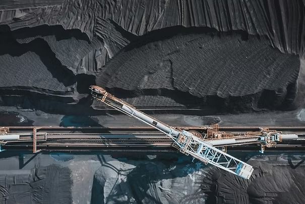 A Conveyor Bridge Moving Dark Coal in an Industrial Mining Site — UAScend Aerial Solutions in Townsville, QLD