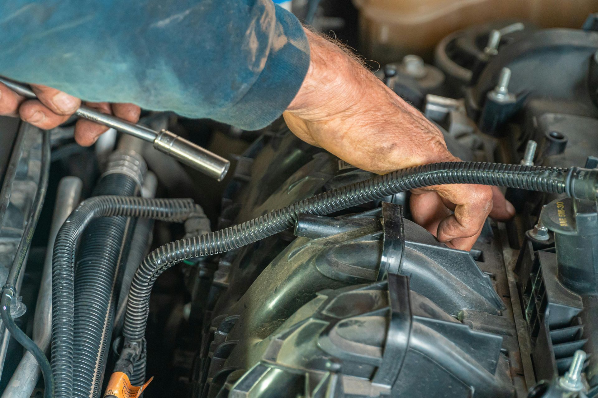 Technician Working On Vehicle Engine Components | Locals Automotive Repair