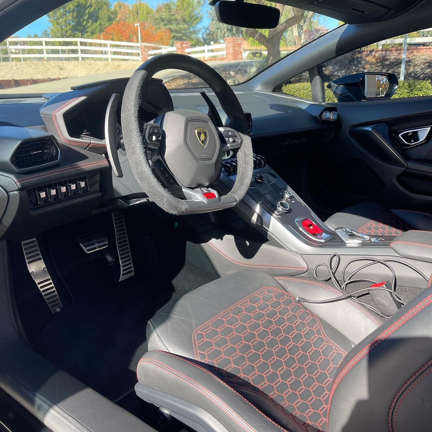 The inside of a car with a steering wheel and seats