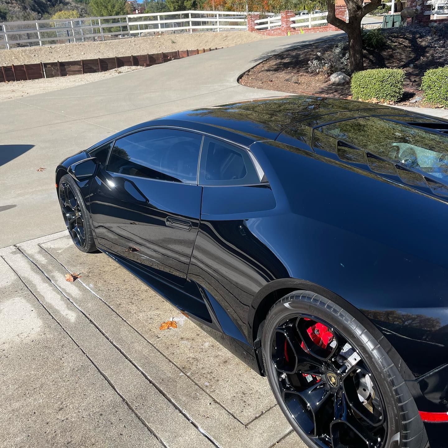 A black sports car is parked on the side of the road