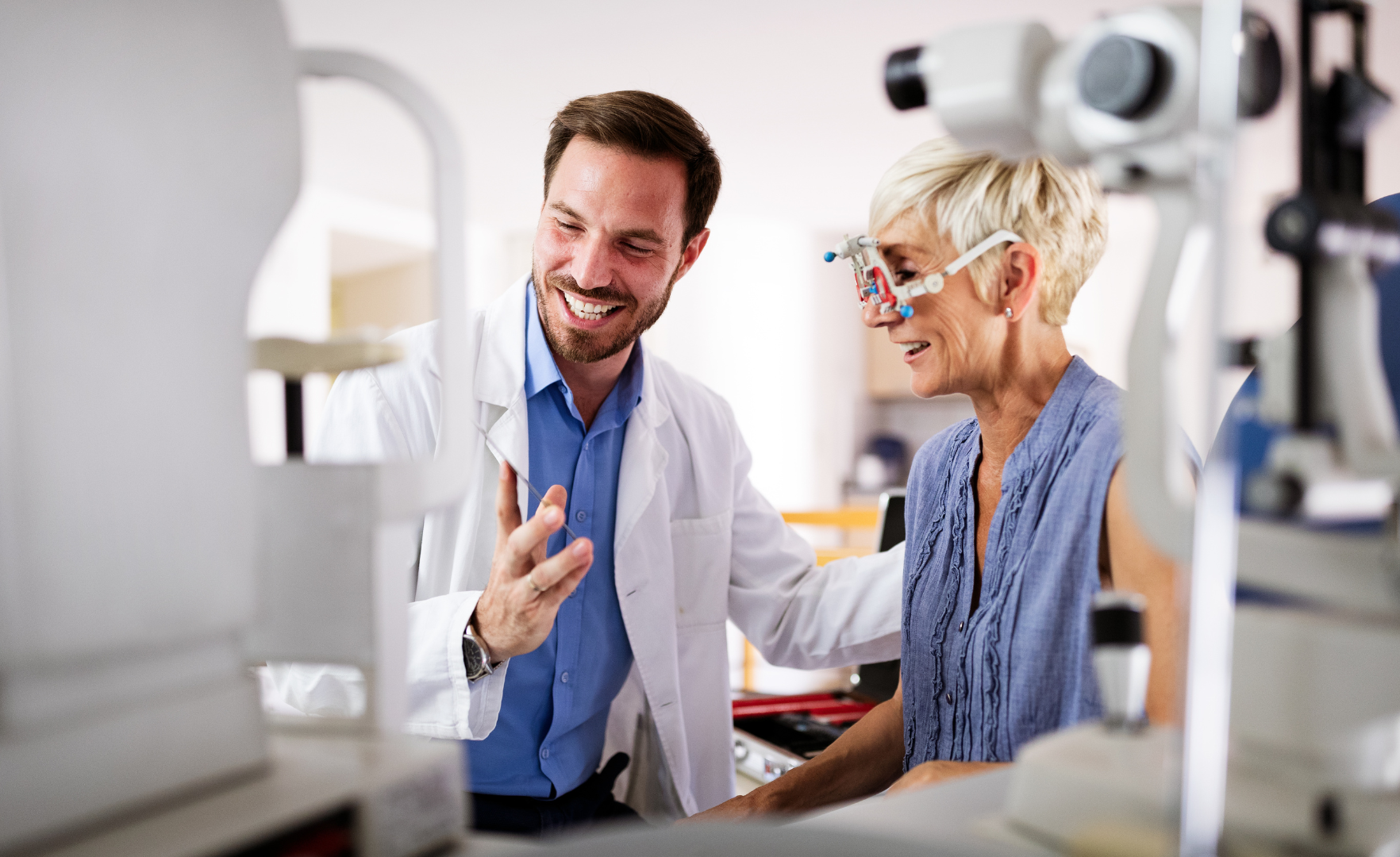 Optometrist consulting a patient in a bright eyeglass shop, reviewing frames together