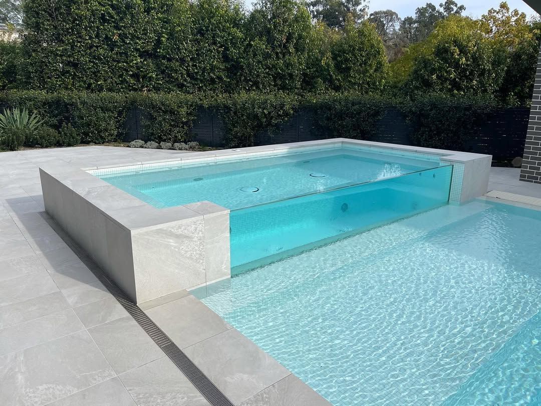 A Modern Swimming Pool With a Clear Glass Section — All Glass Balustrading Systems in Wetherill Park, NSW