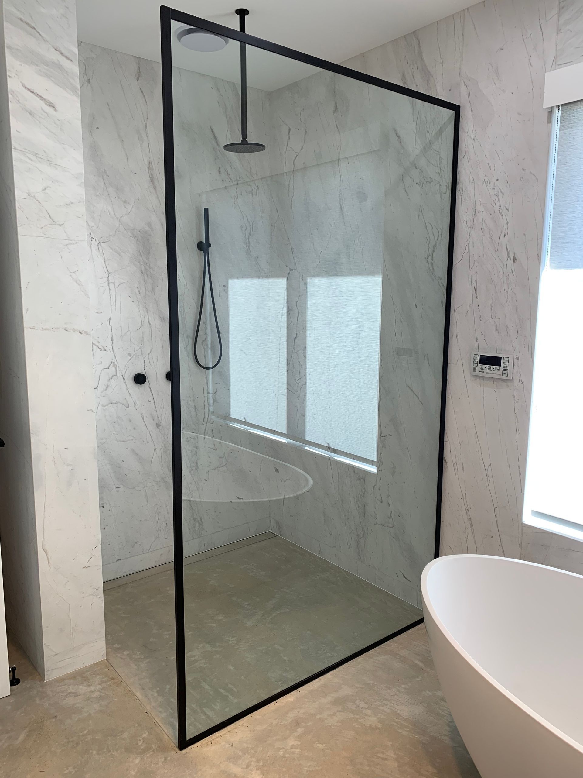Modern Bathroom With a Glass Shower Enclosure and a Freestanding Tub — All Glass Balustrading Systems in Wetherill Park, NSW