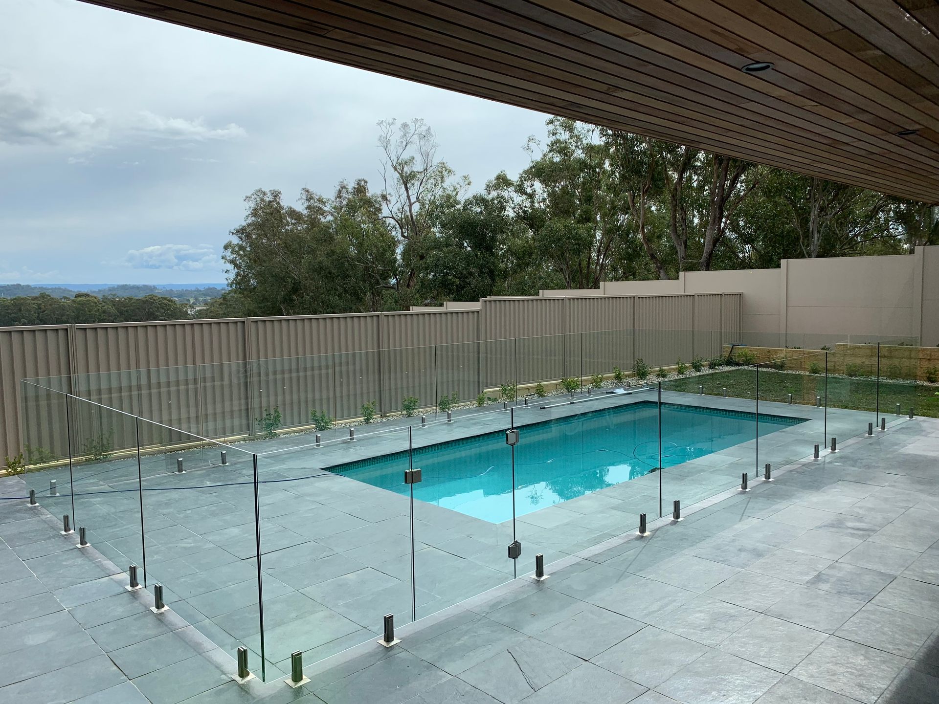 Swimming Pool With Glass Fencing, Grey Patio — All Glass Balustrading Systems in Wetherill Park, NSW