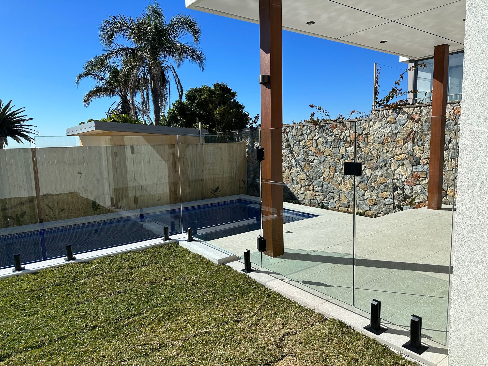 A Large Swimming Pool With a Hose Attached to It — All Glass Balustrading Systems in Wetherill Park, NSW