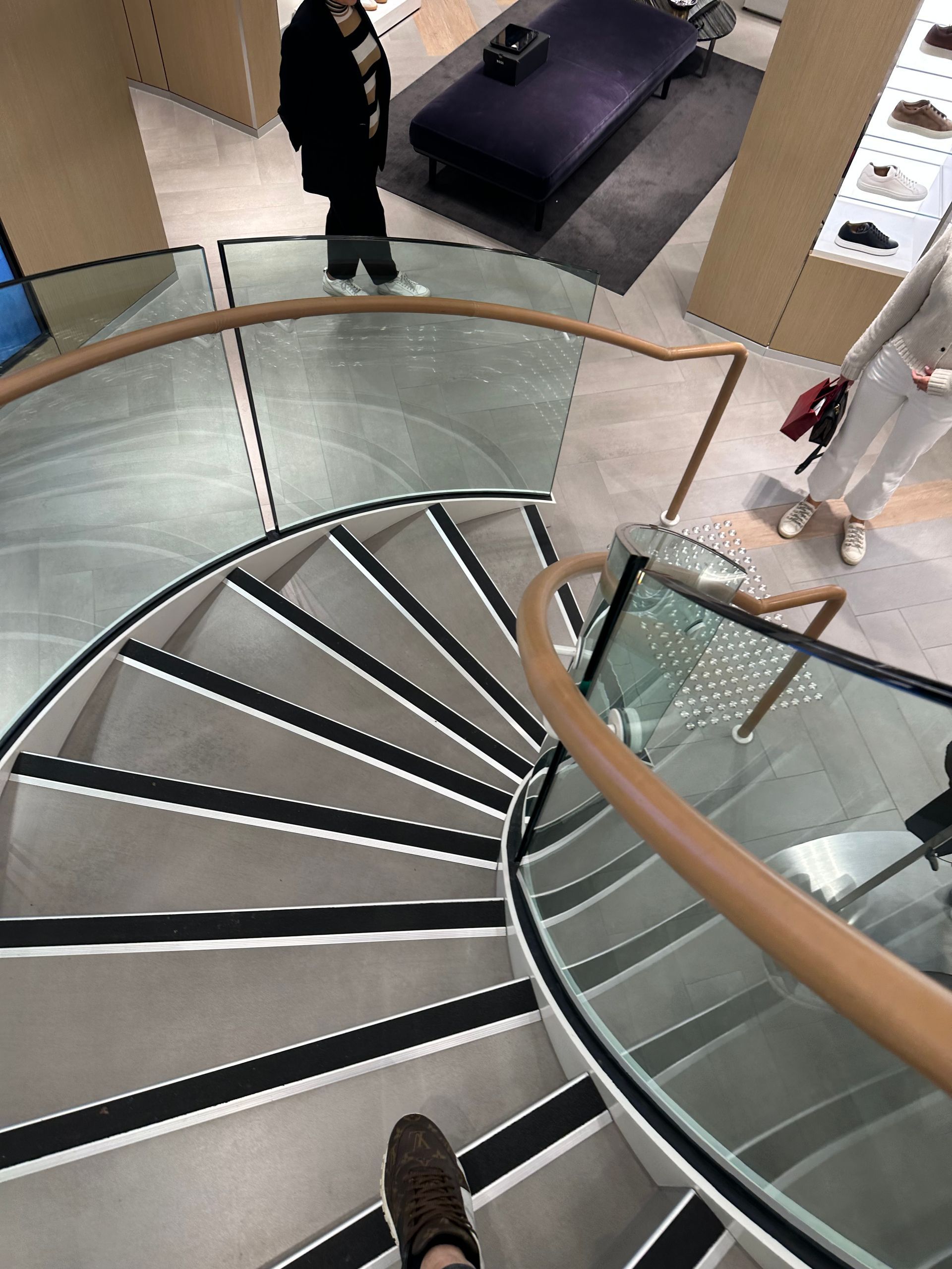 A Staircase With a Glass Railing and Wooden Steps — All Glass Balustrading Systems in Wetherill Park, NSW
