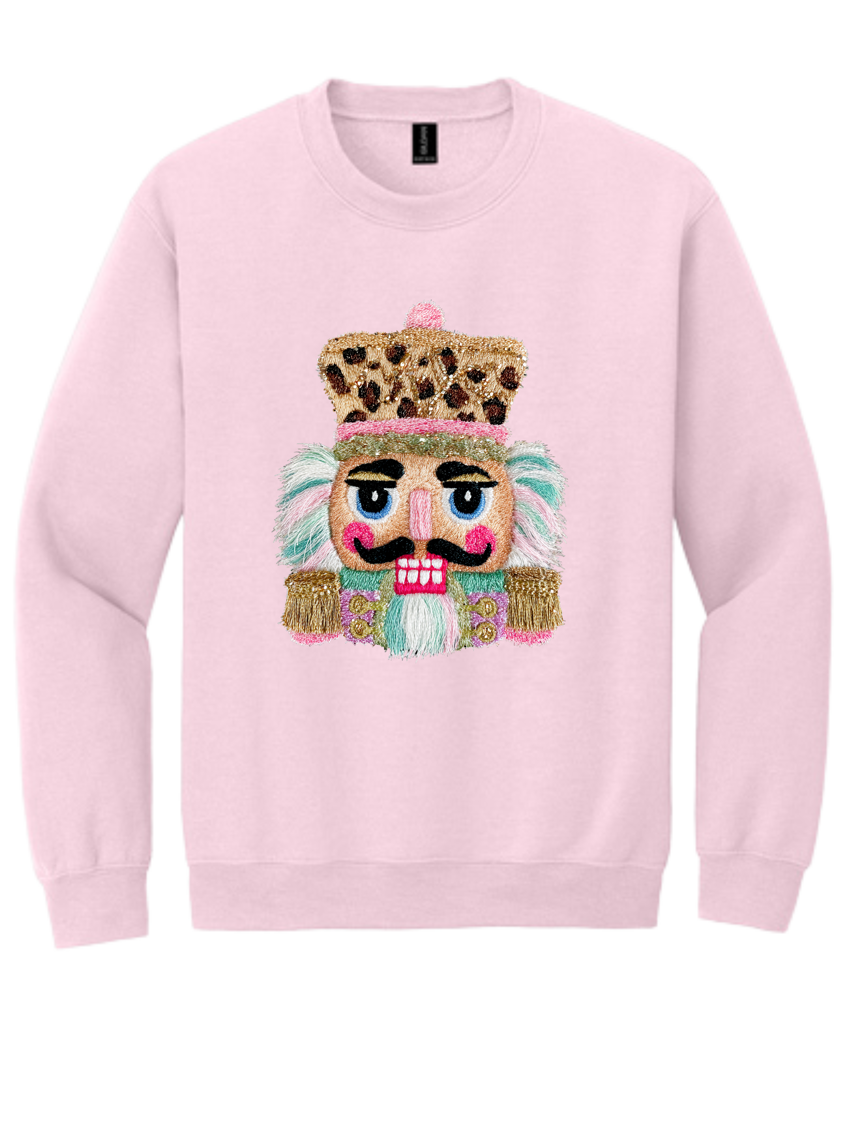 Light pink sweatshirt with a festive nutcracker face graphic and gold crown