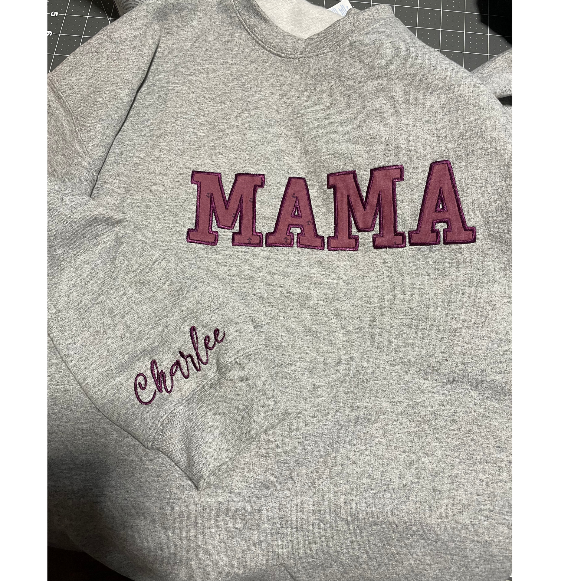 Gray sweatshirt with maroon “MAMA” lettering and a small cursive name embroidered on the left side