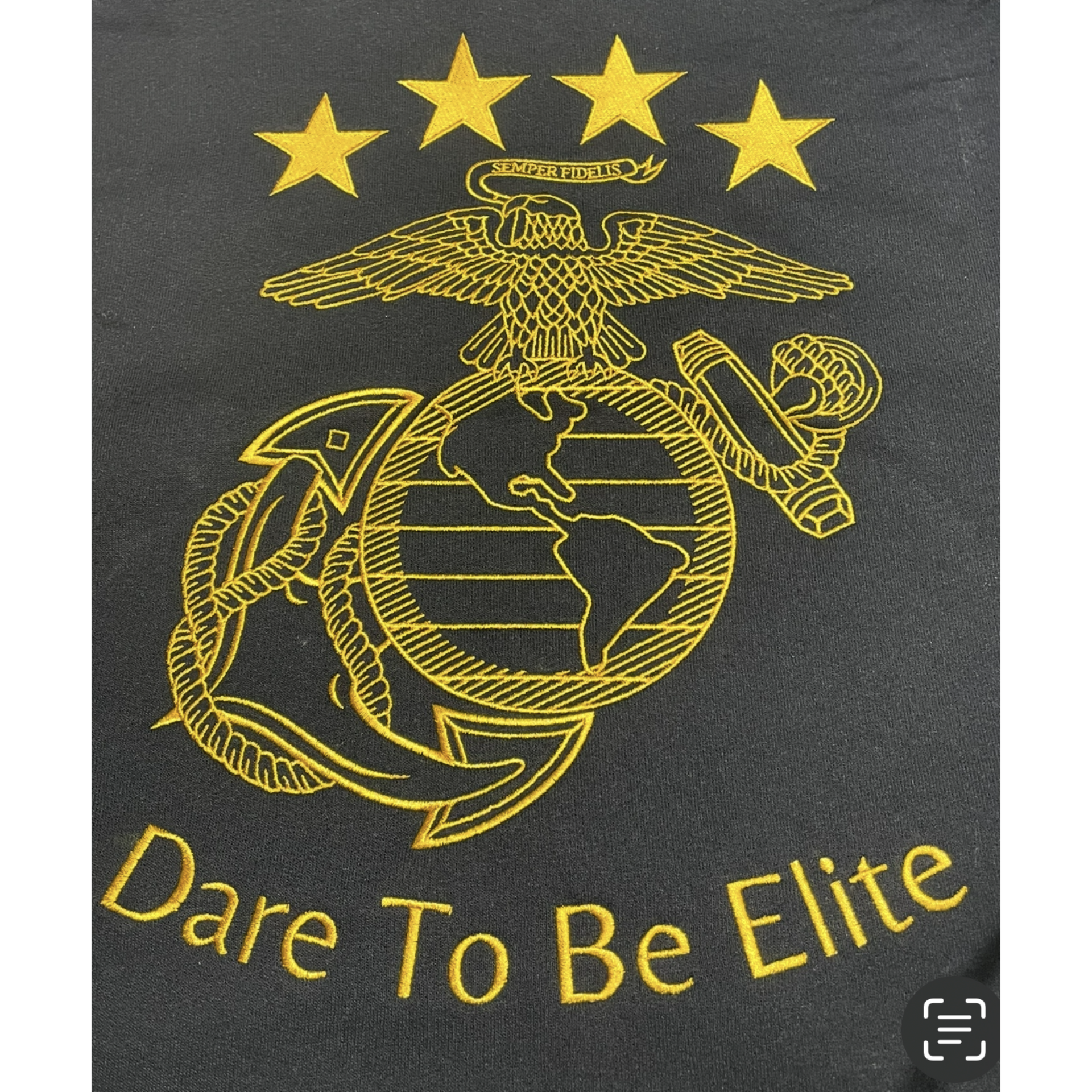 Gold U.S. Marine Corps emblem with stars and “Dare To Be Elite” on a black background