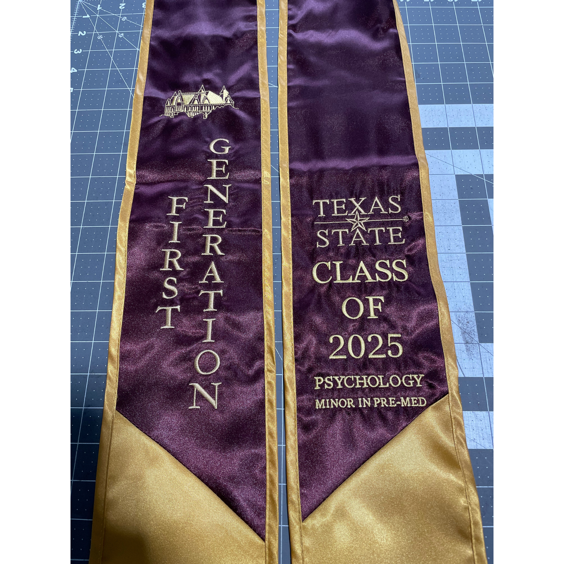 Purple-and-gold graduation stole reading “First Generation” and “Texas State Class of 2025” with psychology honors