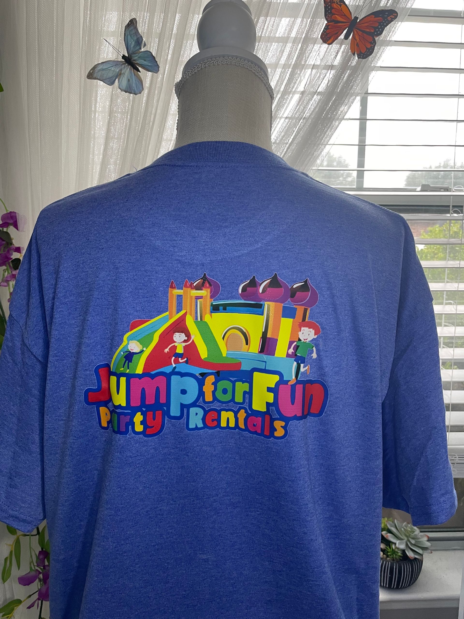 Blue shirt with colorful “Jump for Fun Party Rentals” bounce house logo on a mannequin torso